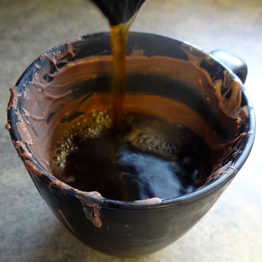 pour coffee into chocolate mug