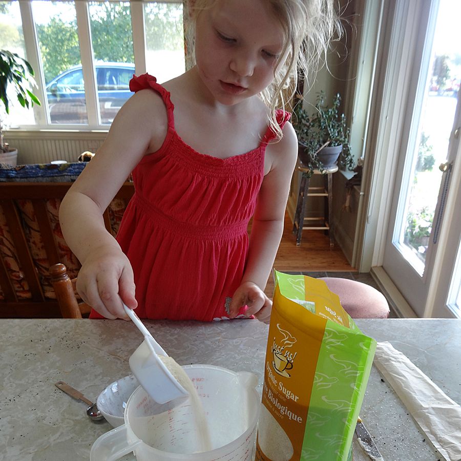 Addison measuring Just Us! Fair trade organic cane sugar