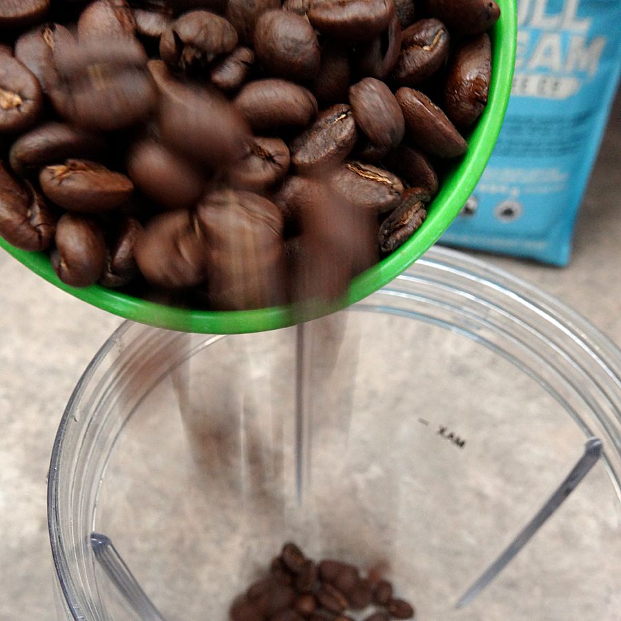 Pour coffee beans in to grind